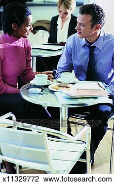 Stock Photo - two business colleagues 
having a discussion 
around a table 
on a. fotosearch 
- search stock 
photos, pictures, 
images, and photo 
clipart