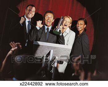 Stock Photo - happy business 
people receiving 
a prize at an 
award ceremony. 
fotosearch - search 
stock photos, 
pictures, images, 
and photo clipart