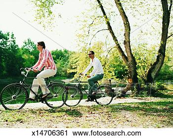 Stock Photography - two men riding 
old fashioned 
bicycles at the 
edge of a lake. 
fotosearch - search 
stock photos, 
pictures, images, 
and photo clipart