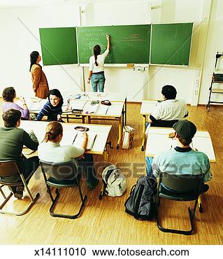 Stock Photography - lecturer with 
students sitting 
behind desks in 
a seminar,  watching 
a. fotosearch 
- search stock 
photos, pictures, 
images, and photo 
clipart