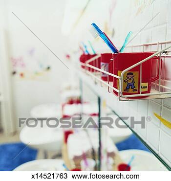 Stock Photo - line of mugs with 
toothbrushes in 
on a rack in a 
school bathroom. 
fotosearch - search 
stock photos, 
pictures, images, 
and photo clipart
