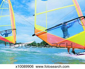Stock Photo - two people windsurfing 
on the sea by 
the coast. fotosearch 
- search stock 
photos, pictures, 
images, and photo 
clipart