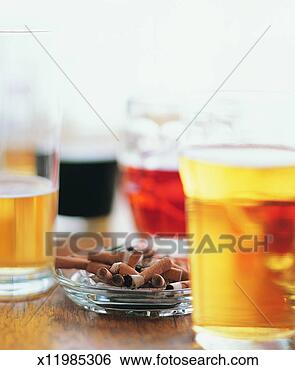 Stock Photo - pint glasses of 
beer with an ashtray 
full of cigarette 
butts. fotosearch 
- search stock 
photos, pictures, 
images, and photo 
clipart