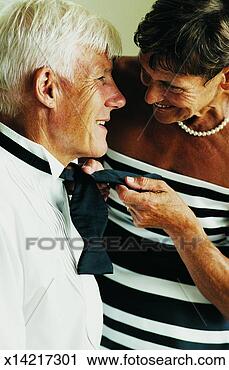 Stock Photography - senior woman helping 
a senior man tying 
his bow tie. fotosearch 
- search stock 
photos, pictures, 
images, and photo 
clipart