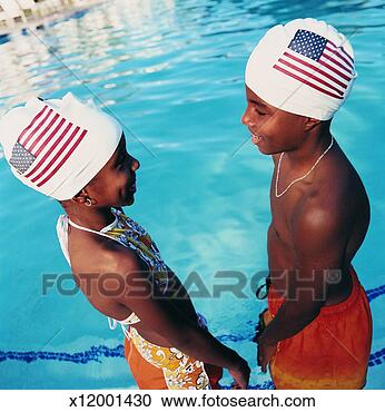 Stock Photography - two teenagers 
face to face standing 
in a swimming 
pool wearing stars. 
fotosearch - search 
stock photos, 
pictures, images, 
and photo clipart