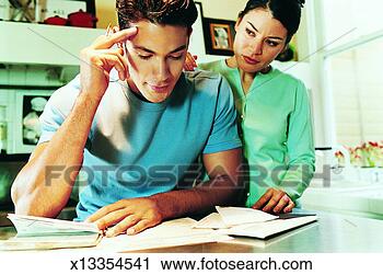 Stock Photography - young adult couple 
in a kitchen, 
woman supporting 
man, man anxious. 
fotosearch - search 
stock photos, 
pictures, images, 
and photo clipart
