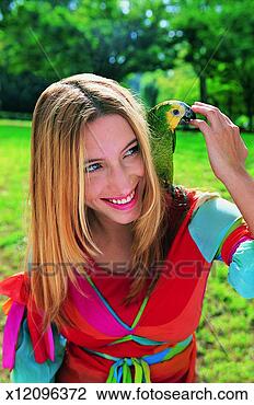 Stock Photo - woman in the park 
with a parrot 
on her shoulder. 
fotosearch - search 
stock photos, 
pictures, images, 
and photo clipart