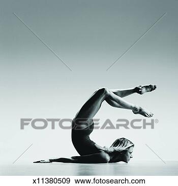 Stock Photograph - woman lying on 
the floor and 
bending her back 
in a curve. fotosearch 
- search stock 
photos, pictures, 
images, and photo 
clipart