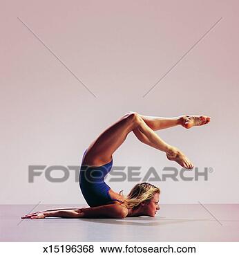 Stock Photo - woman lying on 
the floor and 
bending her back 
in a curve. fotosearch 
- search stock 
photos, pictures, 
images, and photo 
clipart