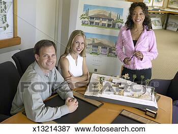 Picture - couple with an 
estate agent in 
an office with 
an architectural 
model. fotosearch 
- search stock 
photos, pictures, 
images, and photo 
clipart
