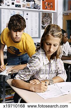 Stock Photo - dishonest male 
student leaning 
over a female 
student's shoulder 
to. fotosearch 
- search stock 
photos, pictures, 
images, and photo 
clipart