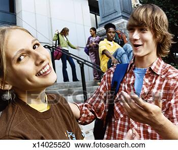 Stock Photography - male student chatting 
up an embarrassed 
looking girl at 
the bottom of. 
fotosearch - search 
stock photos, 
pictures, images, 
and photo clipart