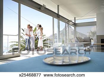 Picture - view of an apartment 
interior,  glasses, 
 and couples talking 
on a. fotosearch 
- search stock 
photos, pictures, 
images, and photo 
clipart