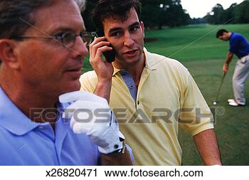 Stock Photography - one man talking 
on cellular phone 
on golf course, 
 one rubbing chin;. 
fotosearch - search 
stock photos, 
pictures, images, 
and photo clipart