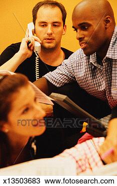 Stock Photo - two men and woman 
in meeting; one 
man on telephone, 
 second man. fotosearch 
- search stock 
photos, pictures, 
images, and photo 
clipart