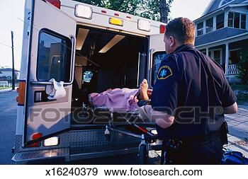Stock Photograph - paramedic loading 
patient on stretcher 
into back of ambulance. 
fotosearch - search 
stock photos, 
pictures, images, 
and photo clipart