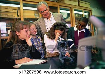 Stock Photo - girl using microscope 
in science class, 
 teacher and classmates. 
fotosearch - search 
stock photos, 
pictures, images, 
and photo clipart