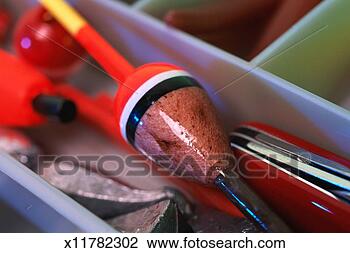 Stock Photo - fishing equipment 
in tackle box; 
float, weights 
and pocketknife. 
fotosearch - search 
stock photos, 
pictures, images, 
and photo clipart