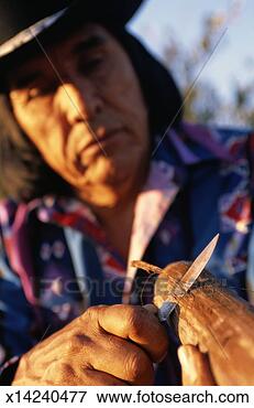 Picture - apache carving 
a string violin. 
fotosearch - search 
stock photos, 
pictures, images, 
and photo clipart