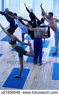 Stock Photo - yoga instructor 
helping students 
in a yoga class. 
fotosearch - search 
stock photos, 
pictures, images, 
and photo clipart