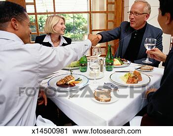 Stock Photography - business people 
shaking hands 
at a business 
lunch. fotosearch 
- search stock 
photos, pictures, 
images, and photo 
clipart