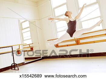 Stock Photograph - ballet dancer 
(14-16) executing 
leap in dance 
studio (high key). 
fotosearch - search 
stock photos, 
pictures, images, 
and photo clipart