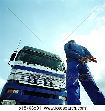 Stock Photography - driver standing 
in front of lorry, 
rear view, low 
angle view. fotosearch 
- search stock 
photos, pictures, 
images, and photo 
clipart