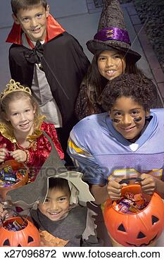 Stock Photo - children (4-8) 
in halloween costumes 
trick-or-treating, 
elevated view. 
fotosearch - search 
stock photos, 
pictures, images, 
and photo clipart