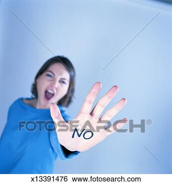Stock Photo - young woman showing 
'no' written on 
hand, focus on 
hand. fotosearch 
- search stock 
photos, pictures, 
images, and photo 
clipart