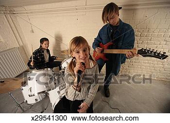 Stock Photography - children (8-15) 
with musical band, 
girl singing into 
microphone. fotosearch 
- search stock 
photos, pictures, 
images, and photo 
clipart