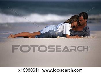 Stock Photography - couple on beach, 
woman kissing 
man on chest. 
fotosearch - search 
stock photos, 
pictures, wall 
murals, images, 
and photo clipart