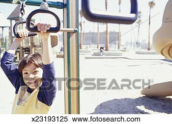 Stock Image - boy (4-5) on playground 
jungle gym, (portrait). 
fotosearch - search 
stock photos, 
pictures, images, 
and photo clipart