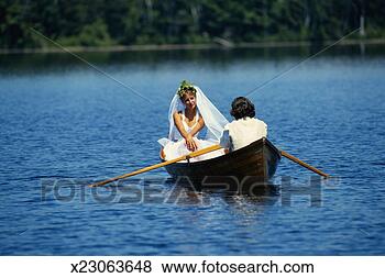 Stock Photo - couple in rowing 
boat on lake, 
 man holding oars, 
 woman in wedding. 
fotosearch - search 
stock photos, 
pictures, images, 
and photo clipart