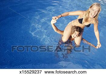 Picture - teenage girl (16-17) 
holding teenage 
girl (16-17) on 
shoulders in. 
fotosearch - search 
stock photos, 
pictures, images, 
and photo clipart