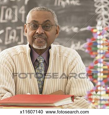 Stock Photography - senior science 
teacher at desk, 
portrait. fotosearch 
- search stock 
photos, pictures, 
images, and photo 
clipart