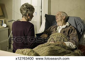 Stock Photography - senior doctor 
checking blood 
pressure of senior 
man in bed in. 
fotosearch - search 
stock photos, 
pictures, images, 
and photo clipart