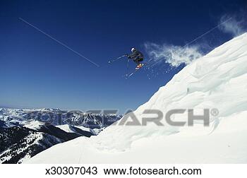 Stock Photo - side view of skier 
in mid-air with 
blue sky background. 
fotosearch - search 
stock photos, 
pictures, images, 
and photo clipart