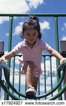 Picture - young girl (4-5) 
on jungle gym, 
low angle view. 
fotosearch - search 
stock photos, 
pictures, images, 
and photo clipart
