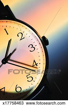 Stock Photo - part of a watch 
face can be seen 
as many colors 
run across it. 
fotosearch - search 
stock photos, 
pictures, images, 
and photo clipart