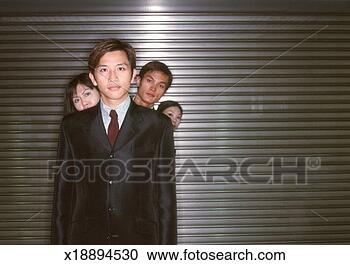 Stock Photography - 'business people 
standing one in 
front of the other, 
 leaning round. 
fotosearch - search 
stock photos, 
pictures, images, 
and photo clipart
