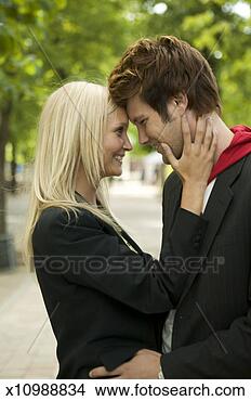 Stock Photo - lifestyle shot 
of a young adult 
couple as they 
lovingly embrace. 
fotosearch - search 
stock photos, 
pictures, images, 
and photo clipart