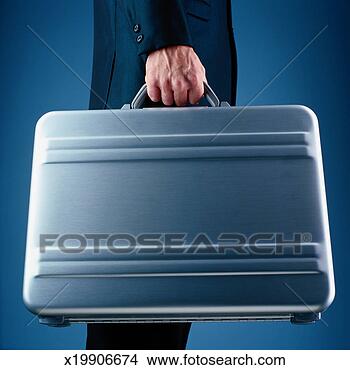 Stock Photo - businessman holding 
a briefcase. fotosearch 
- search stock 
photos, pictures, 
images, and photo 
clipart