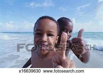 Stock Photography - two young boys 
at the beach giving 
the peace sign 
and the thumbs 
up. fotosearch 
- search stock 
photos, pictures, 
images, and photo 
clipart