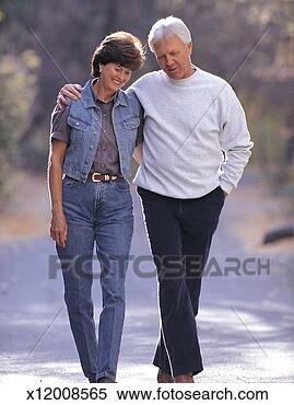 Stock Image - an older man wearing 
black pants and 
a white shirt 
and an older woman. 
fotosearch - search 
stock photos, 
pictures, images, 
and photo clipart