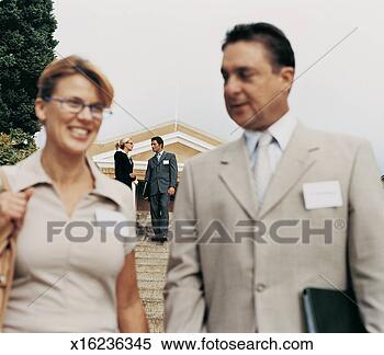 Stock Image - two business executives 
having a discussion 
on steps behind 
another. fotosearch 
- search stock 
photos, pictures, 
images, and photo 
clipart