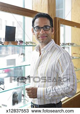 Stock Photo - man standing next 
to window display 
in eyeglass shop. 
fotosearch - search 
stock photos, 
pictures, images, 
and photo clipart