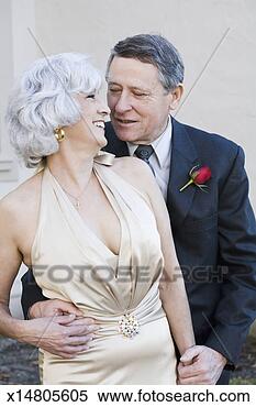 Stock Image - mature well-dressed 
couple, woman 
looking over shoulder, 
outdoors. fotosearch 
- search stock 
photos, pictures, 
images, and photo 
clipart