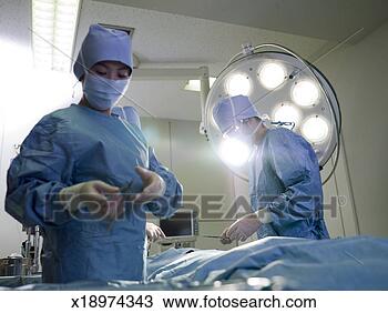 Stock Photo - nurse preparing 
instrument for 
doctor in operating 
room. fotosearch 
- search stock 
photos, pictures, 
images, and photo 
clipart