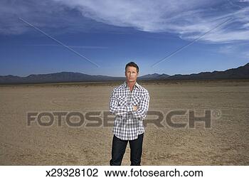 Stock Photo - usa,  nevada, 
 portrait of mature 
man in desert, 
 mountain range 
in. fotosearch 
- search stock 
photos, pictures, 
images, and photo 
clipart