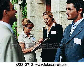 Stock Photo - business executive 
and a businesswoman 
holding a clipboard 
and. fotosearch 
- search stock 
photos, pictures, 
images, and photo 
clipart